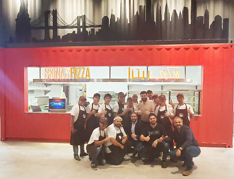 Group Shot of Skinny Pizza Team Posing in Front of Mall Saudi Arbia